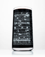 A Stratigraphy Core Sample Drinking Glass by Cognitive Surplus with a black design on it.